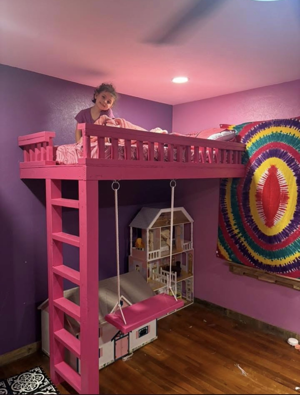 Custom pink loft bed with built-in ladder and hanging swing